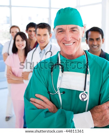 Multi-ethnic medical group smiling at the camera in a hospital