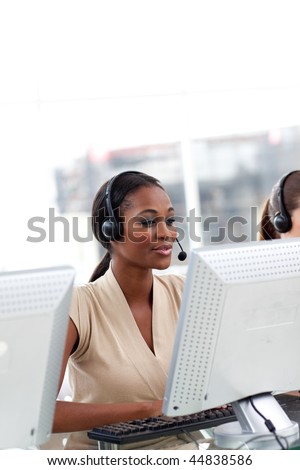 Female customer service agent with headset on working at a computer