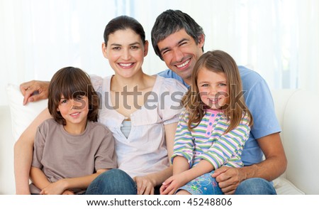 Portrait of a happy family sitting on a sofa