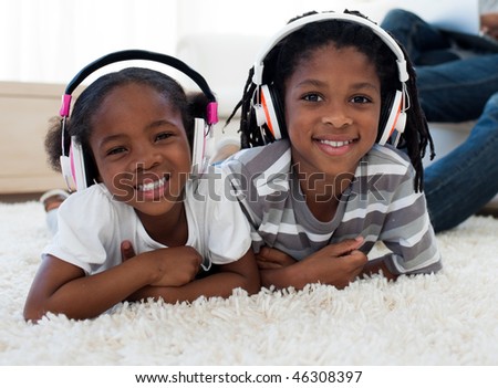 Adorable siblings listening music in the living room