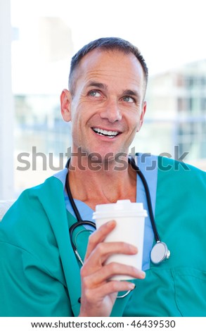 Mature doctor having a break  in the staff room