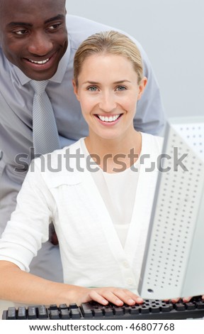 Afro-american businessman and his colleague working at a computer in the office