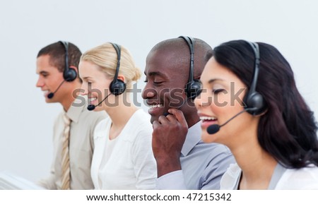 Laughing business people working in a call center in the office