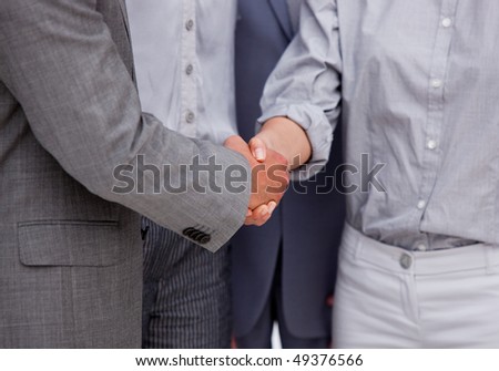 Close-up of a victorious business team closing a deal in a meeting