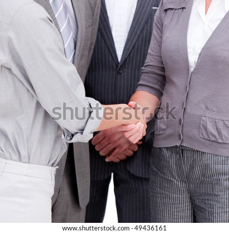 Close-up of a positive business team closing a deal in a meeting
