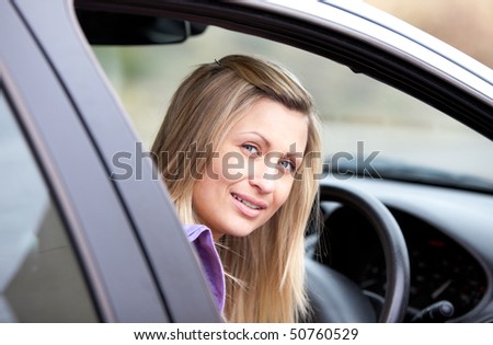 Portrait of an attractive young female driver sitting in her car