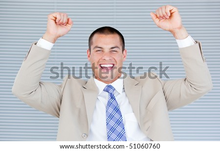 Successful businessman punching the air in celebration