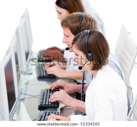 Serious business team working in a call center against a white background