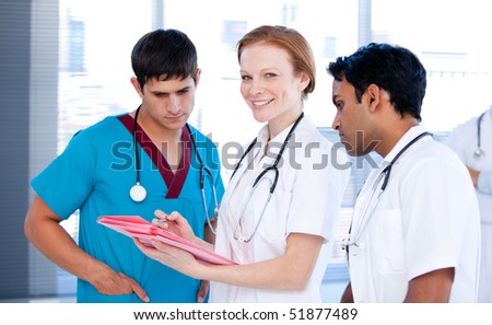 Cheerful female doctor working with her team in a hospital