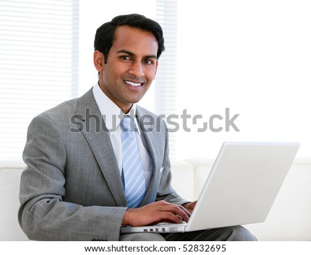 Confident businessman working on his computer in the office