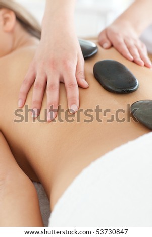 Close-up of a delighted woman relaxing on a massage table against a white background
