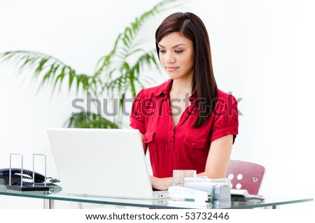 Charismatic businesswoman working at a computer in the office