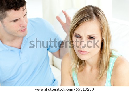 Young couple having an argue in the living-room at home