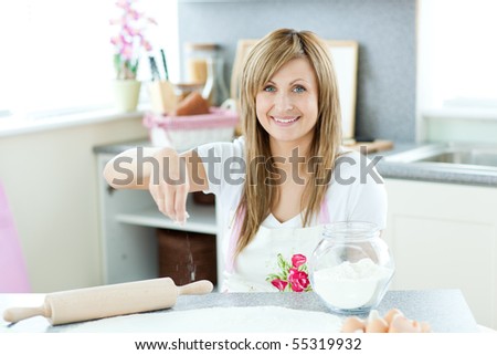 Attractive woman cooking cakes in the kitchen at home