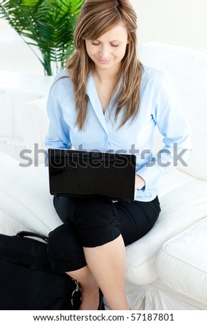 concentrated businesswoman sitting in her office in front of the table with many tasks