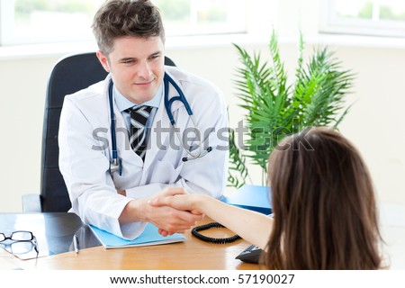 Delighted male doctor welcome his patient in his practice