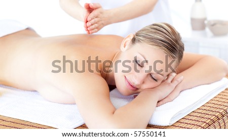 Attractive woman having a massage with massage oil in a spa