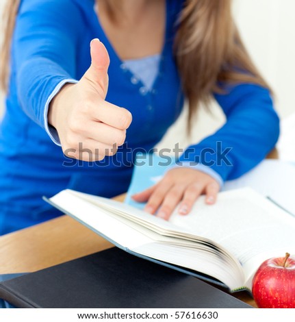 Blond woman reading a book thumb up