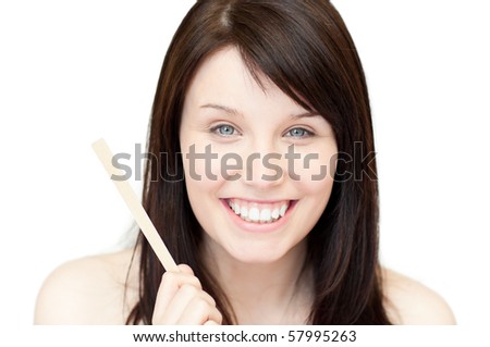 Portrait of a glowing young woman holding a nail file against white background
