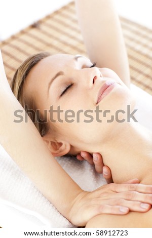 Pretty young woman getting a massage in a health center