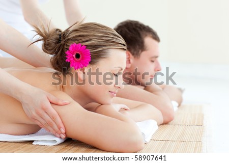 Young couple enjoying a back massage in a spa center