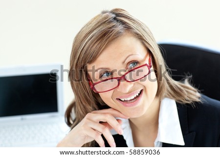 Charming businesswoman sitting on a chair wearing glasses against white background