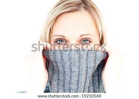 Delighted woman wearing a polo-neck-sweater smiling at the camera against white background