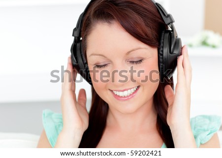 Animated young woman listen to music with headphones at home