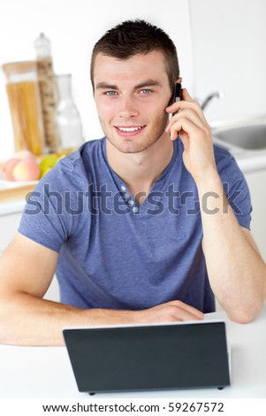 Attractive man talking on phone looking at the camera at home