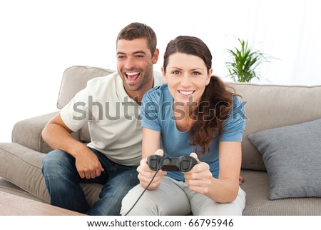 Portrait of a woman playing video game with her boyfriend in the living room