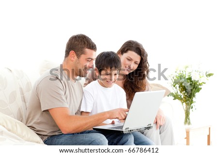 Handsome man showing something on the laptop screen to his family