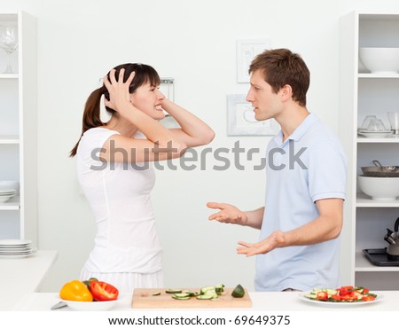 Young lovers having dispute in the kitchen at home