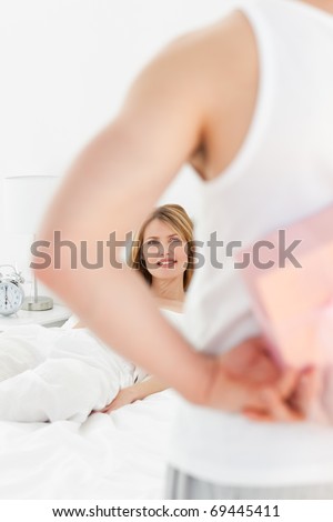 Man offering present to his girlfriend at home