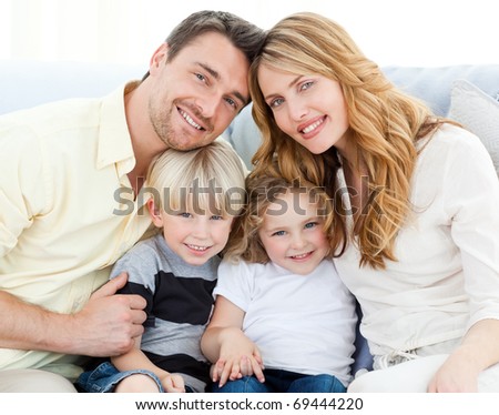 Cute family on their sofa at home