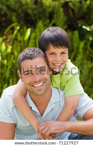 Father with his son hugging in the garden