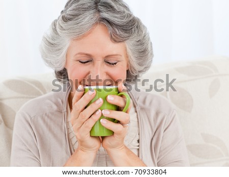 Senior drinking a cup of tea at home