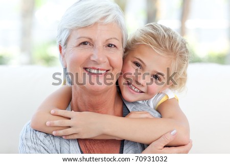 Lovely little girl with her grandmother looking at the camera