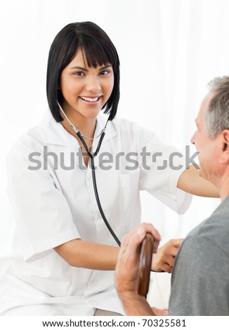 Senior laughing with his nurse at home