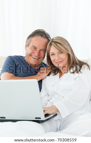 Couple looking at the camera at home