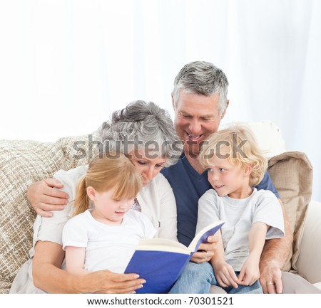 Family looking at a photo album in the living room