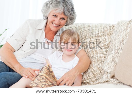 Grandmother helping her little girl to knit