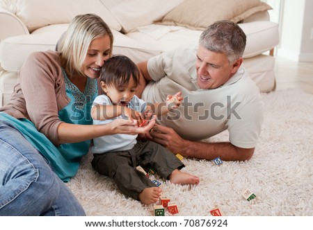 Son playing with his parents at home