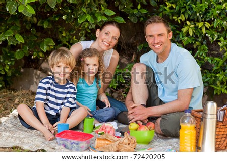 Happy family picnicking in the garden