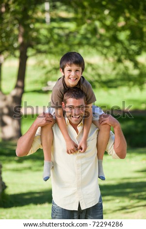 Handsome man giving son a piggyback