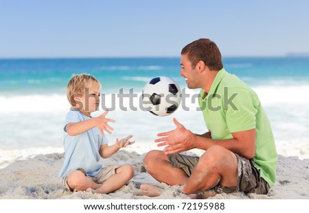 Happy father playing football with his son