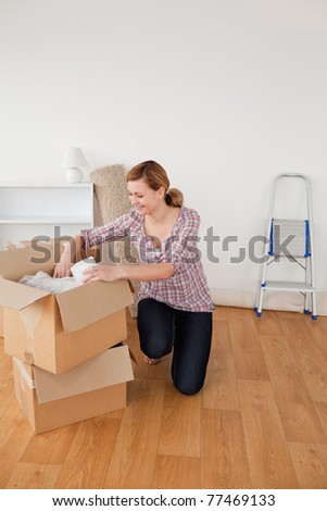 Beautiful blond-haired woman preparing to move house