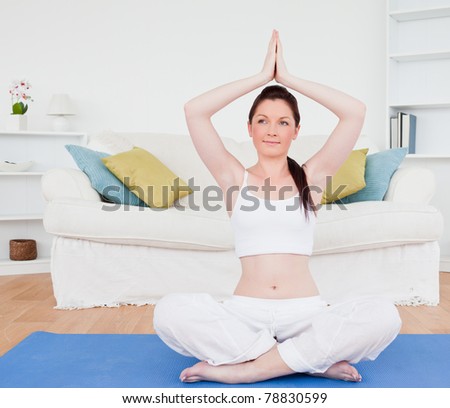 Good looking female doing relaxation on a gym carpet in the living room