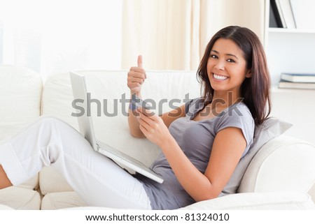 smiling woman with thumb up in living room
