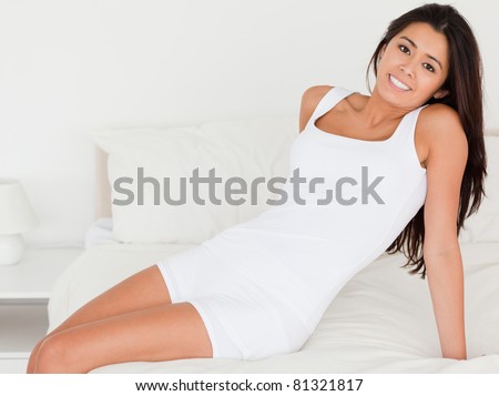 smiling woman looking into camera in bedroom