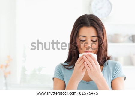 Charming woman enjoying a cup of coffee in the kitchen
